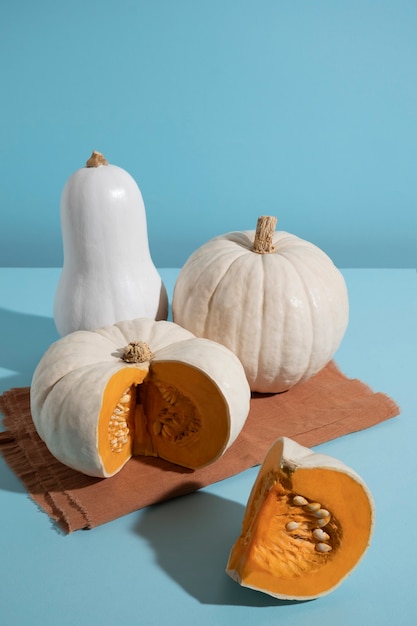 White pumpkins on blue background high angle