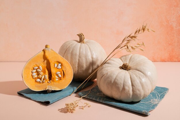 White pumpkins with pink background