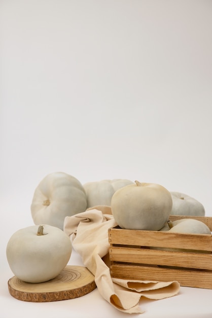 Free Photo white pumpkins and wooden box arrangement