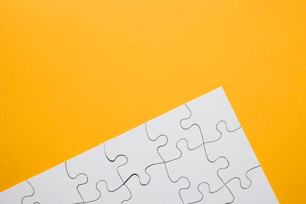 White puzzle grid over yellow background