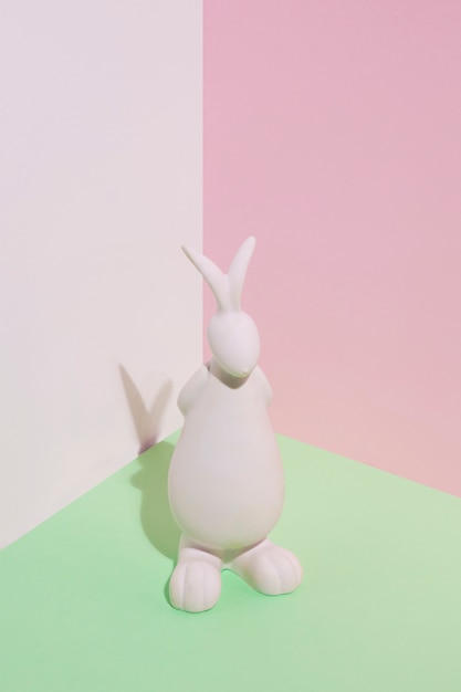 Free photo white rabbit figurine on green table