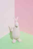 Free photo white rabbit figurine on green table