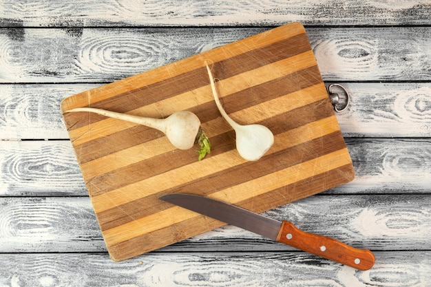 Free Photo white radish ripe on brown wooden desk and rustic floor