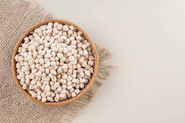 White raw pea beans on a platter on concrete.