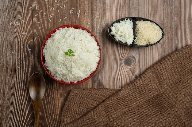 Free photo white rice is placed in a cup on the wooden floor.