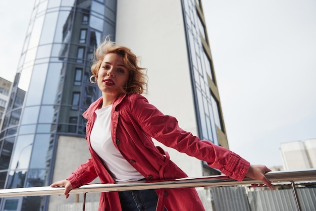 Free photo in white shirt. adult pretty woman in warm red coat have walk in the city at her weekends time