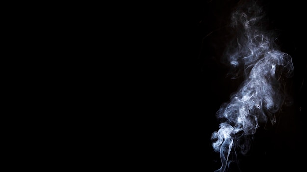 White smoke on black background with copy space for writing the text