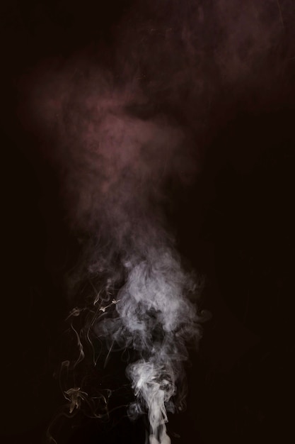 Free photo white smoke blowing against black background