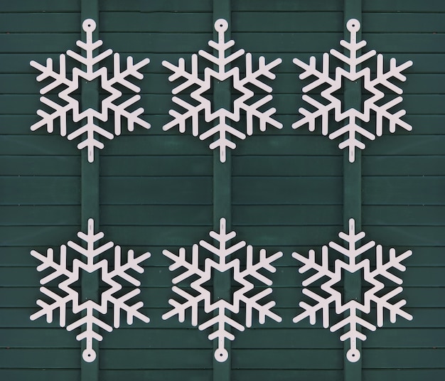 Free Photo white snowflake on green wooden door christmas decoration