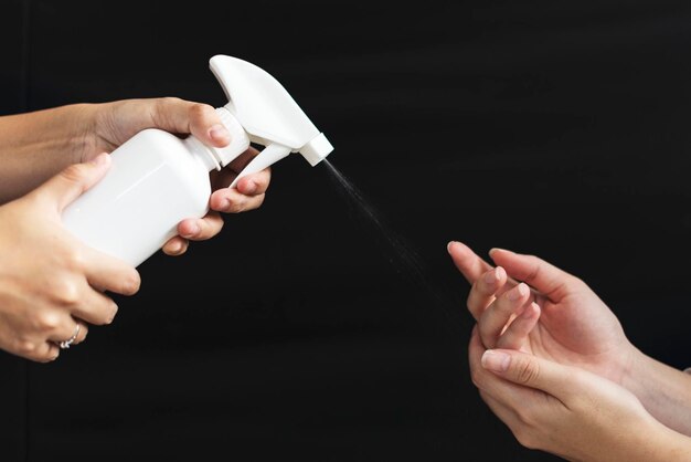 White spray bottle on a black background