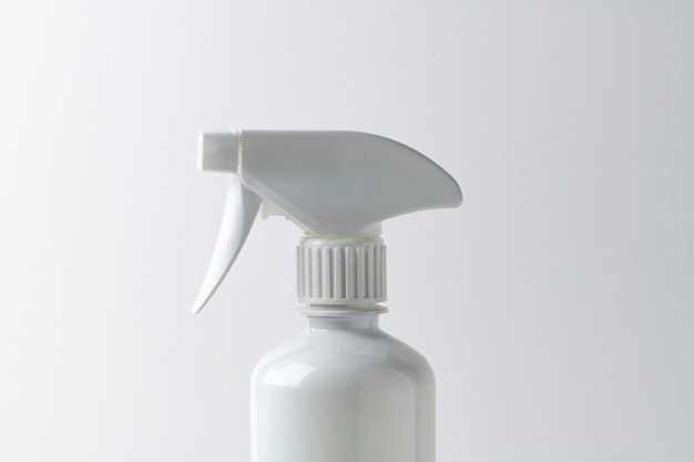 Free photo white spray bottle on a plain surface