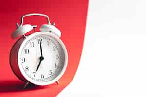 Free photo white stylish alarm clock on viva magenta background