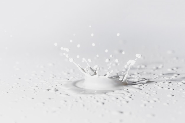 Free photo white surface with splash of milk