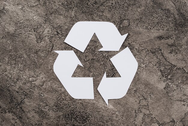 Free Photo white symbol of recycling on dirty background