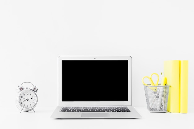 White table with laptop and notebooks