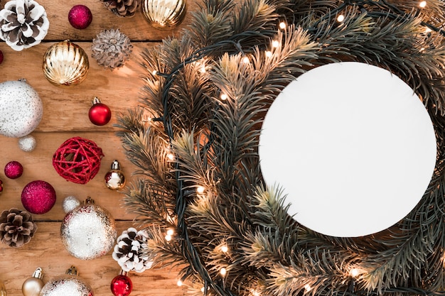 White tablet between fir twigs and Christmas decorations 