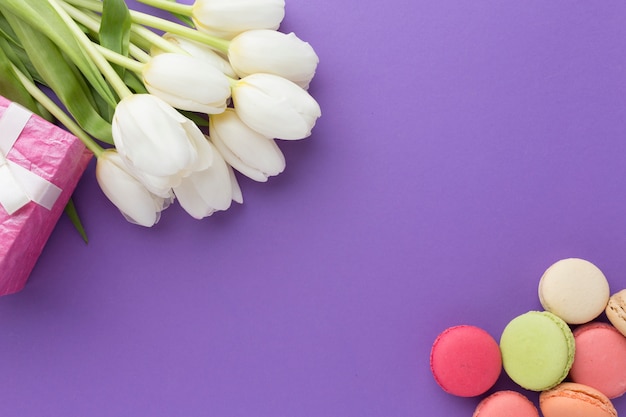 White tulip flowers and sweets top view