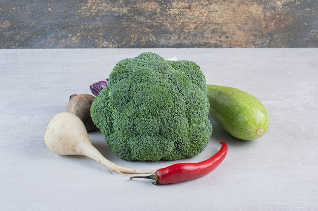 White turnip, broccoli and chili pepper on stone surface. High quality photo