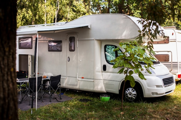 White van with table and chairs next to it