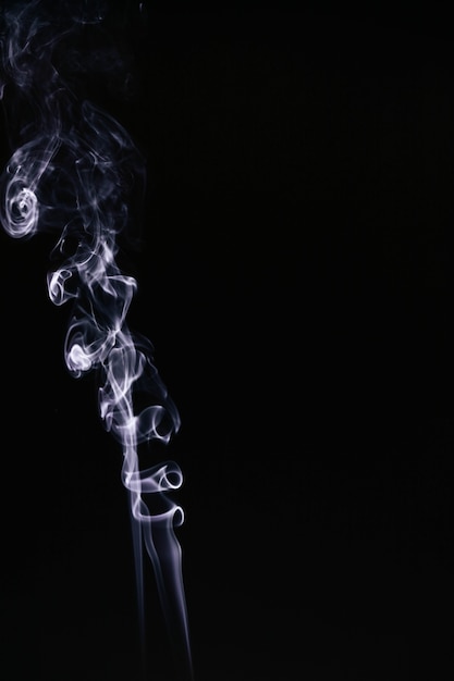 Free photo white wavy smoke on black background