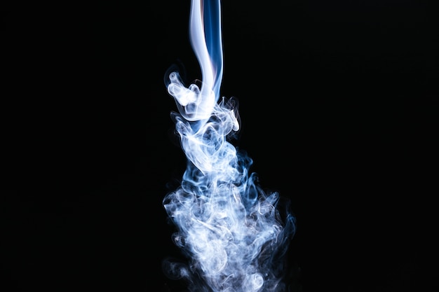 Free photo white wavy smoke on black background