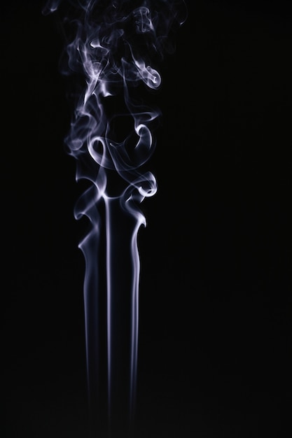 White wavy smoke on black background