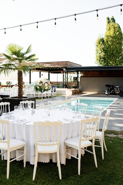 White wedding venue with a swimming pool.