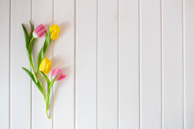 White wooden surface with pretty tulips