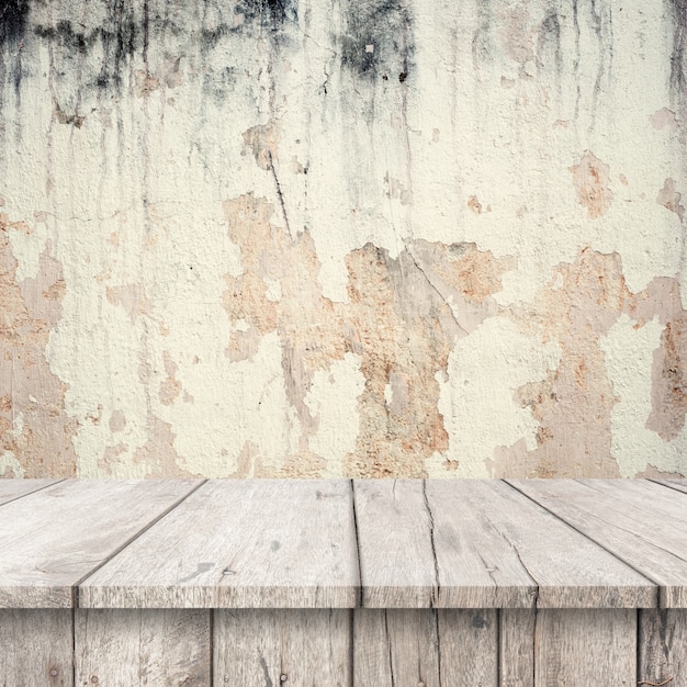 Free Photo white wooden tables with a very damaged wall