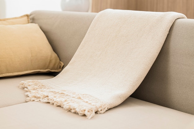 White woven throw blanket on sofa