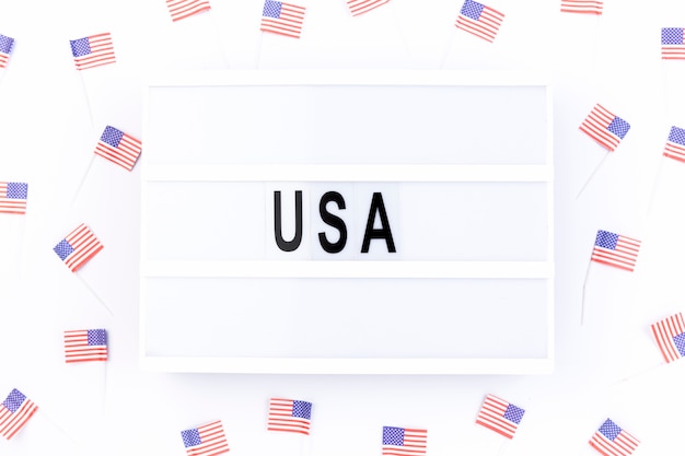 Free Photo whiteboard with note usa surrounded by small american flags 