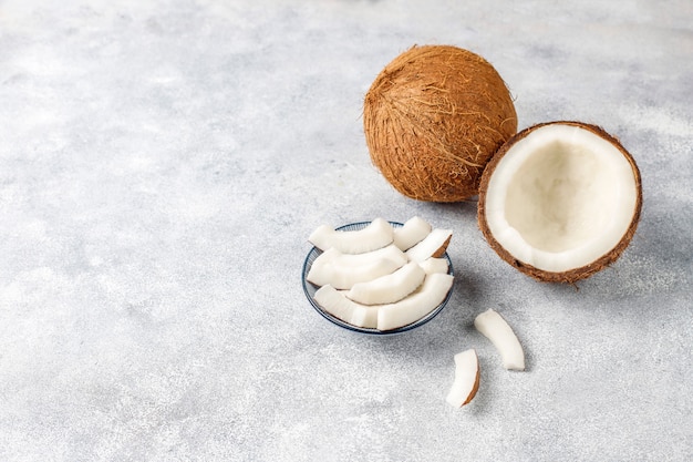 Whole coconut and various pieces of coconut