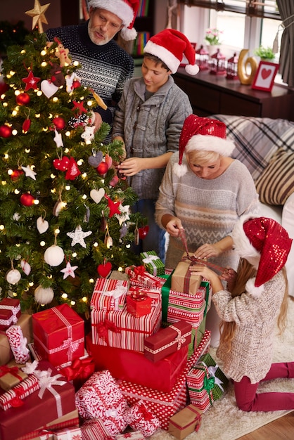 Whole family around the Christmas tree