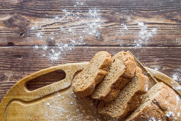 Whole wheat bread on wooden table top view