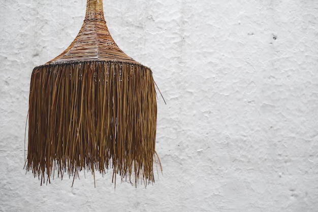 Free photo wicker chandelier in a cafe on the background of a white wall interior design idea selective focus on the chandelier style