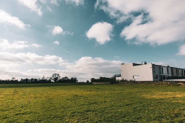 Free Photo wide angle shot of a building surrounded by green landscape