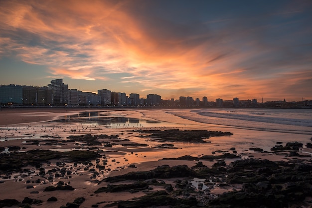 Wide shot of city buildings near the seashore in Gijon