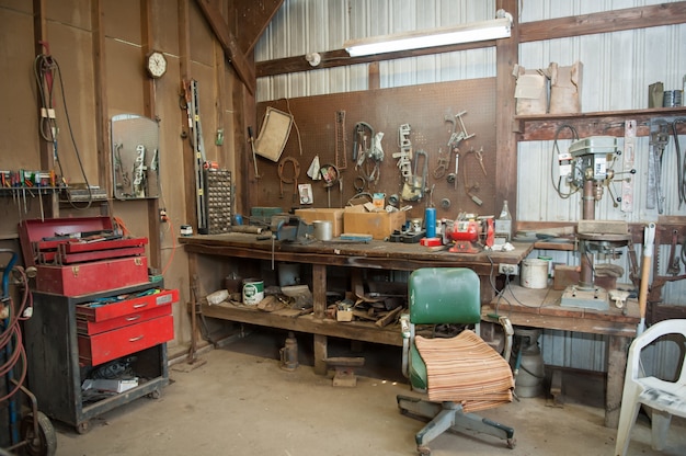 Free Photo wide shot of an old barn' s workbench with different types of tools