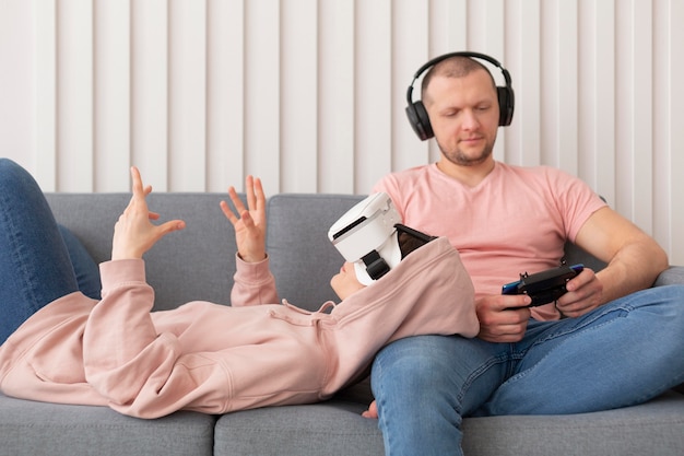 Wife and husband playing videogames at home