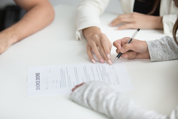 Wife signing divorce decree after break up decision