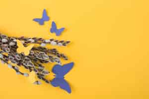 Free photo willow branches with paper butterflies on table