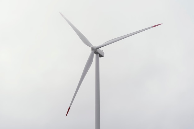 Free photo wind turbine against cloudy sky