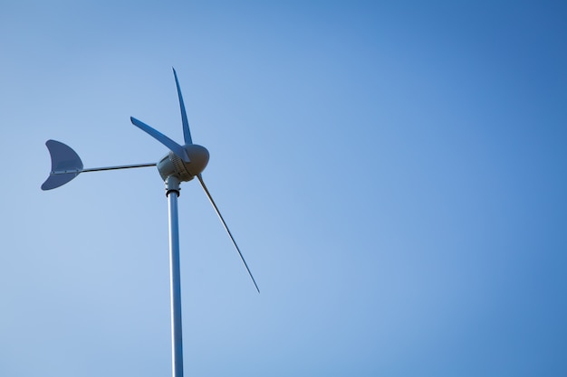 Free photo wind turbine over blue sky