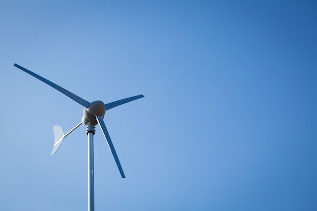 Wind turbine over blue sky