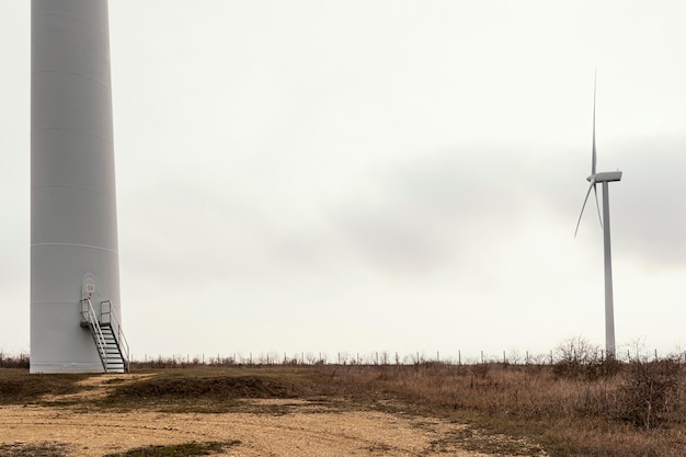 Free photo wind turbines in the field with copy space