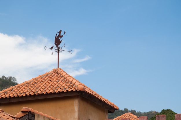 Free photo windmill and witch on the rooftop with blue sky