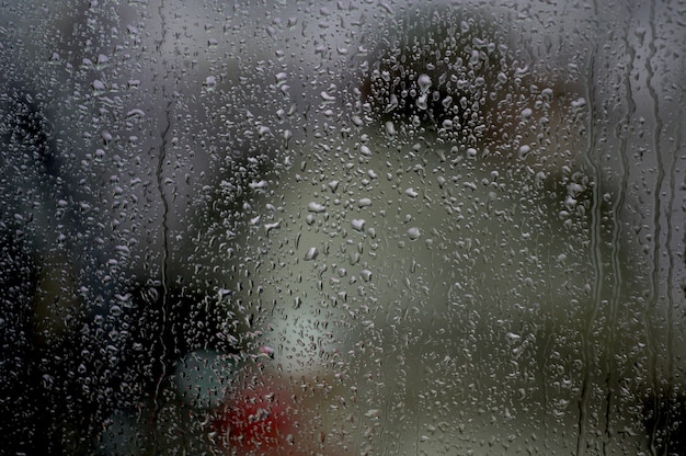 Window with raindrops on it under the lights