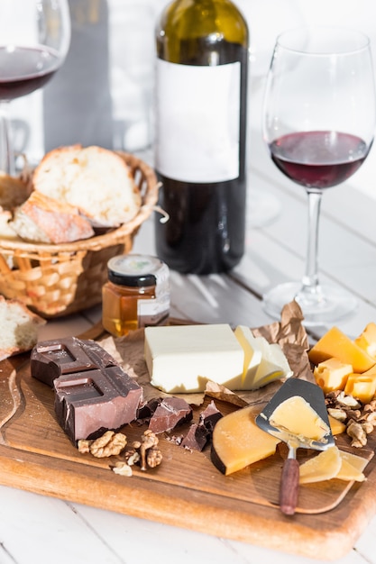 Free Photo wine, baguette and cheese on wooden background