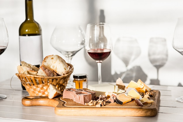 Free Photo wine, baguette and cheese on wooden