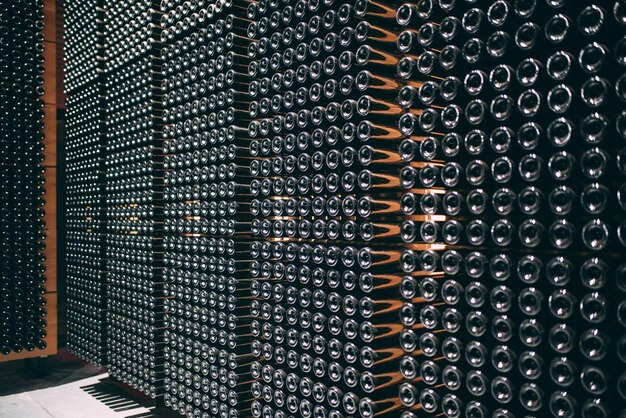 Wine bottles stored in a winery on the fermentation process